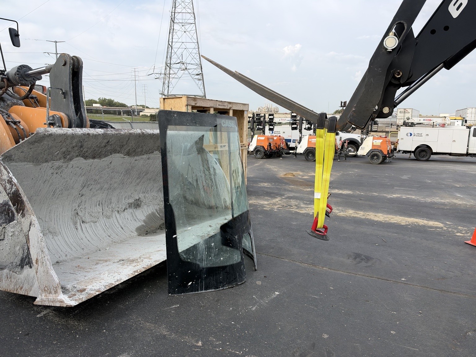 Removed windshield set beside the CASE wheel loader during the job